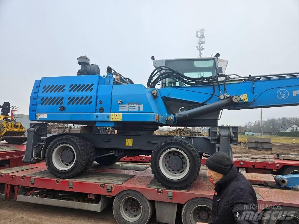 Fuchs MHL 331 Paleta de manipulare